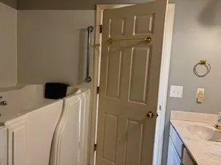 a bathroom with a granite countertop shower a sink and a mirror