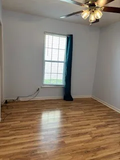 a view of a room with wooden floor and window