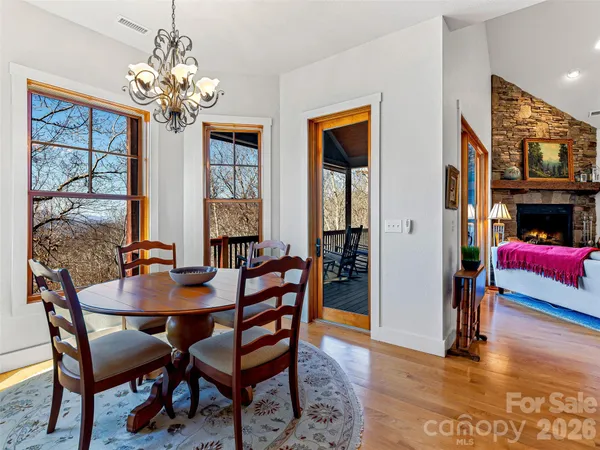 a kitchen with stainless steel appliances granite countertop a refrigerator a stove and a sink with wooden floor