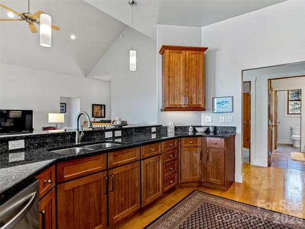 a kitchen with stainless steel appliances granite countertop a stove a sink and a granite counter tops