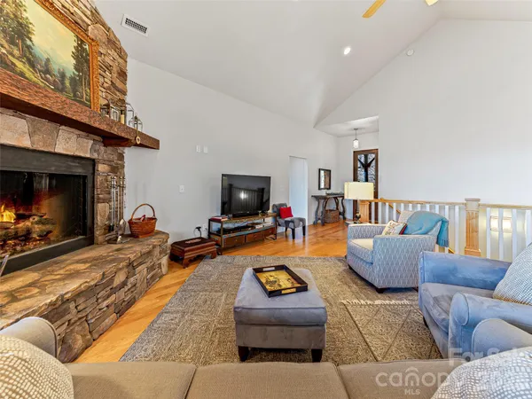 a dining room with furniture a chandelier and wooden floor