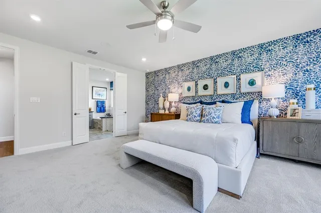 a spacious bedroom with a bed and a chandelier