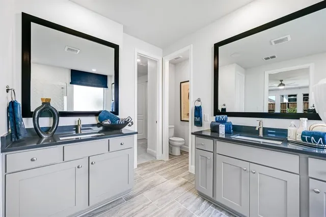 a kitchen with white cabinets and sink