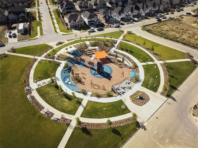 an aerial view of residential houses with outdoor space