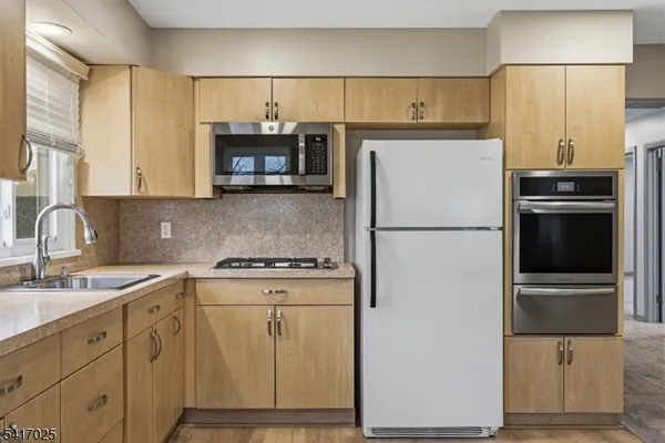 a kitchen with appliances a sink and a cabinets