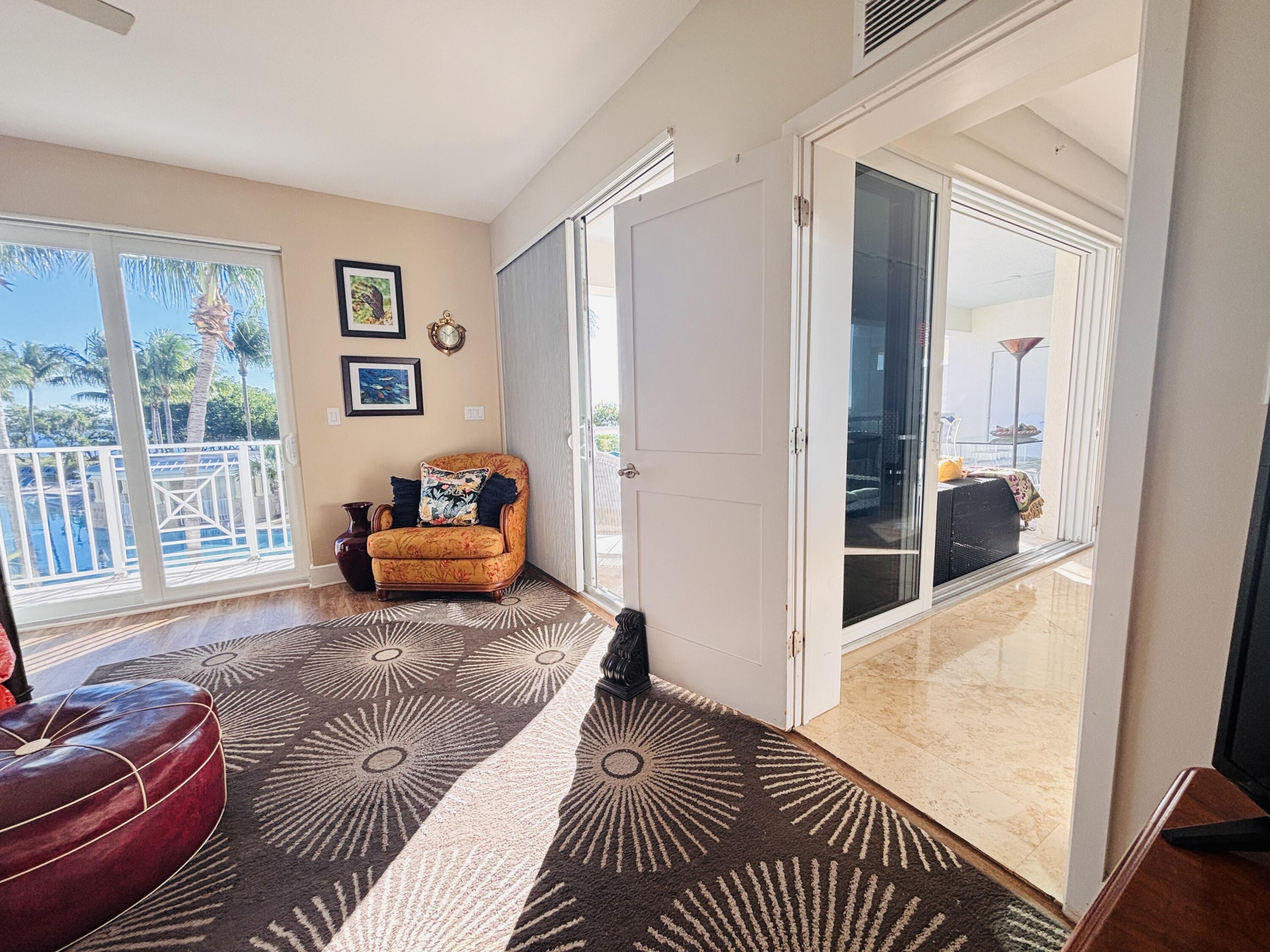 97501 Overseas Highway, Unit 521 Key Largo, FL 33037 - Photo 15 of 38 a bedroom with furniture and a window