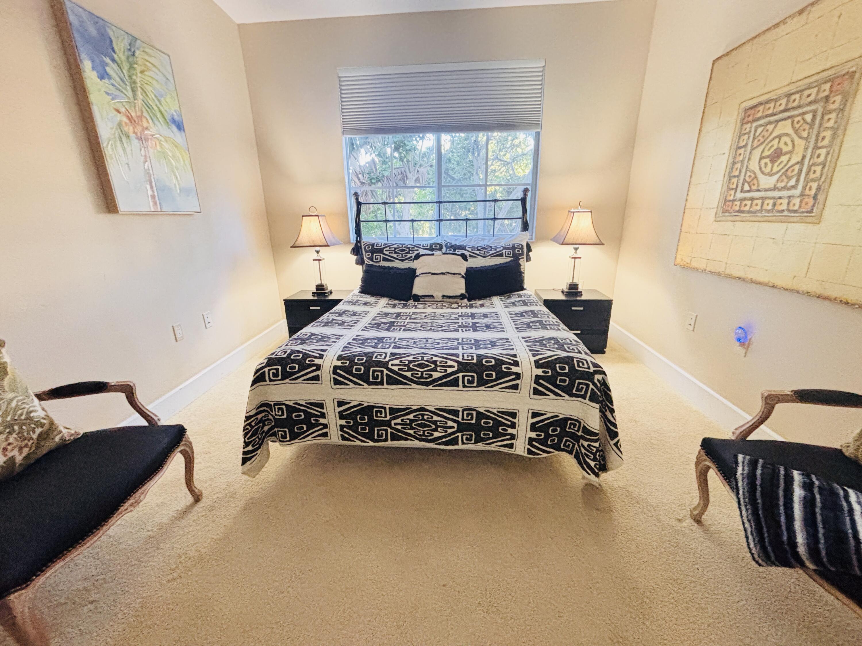 97501 Overseas Highway, Unit 521 Key Largo, FL 33037 - Photo 16 of 38 a bed sitting in a bedroom next to a window