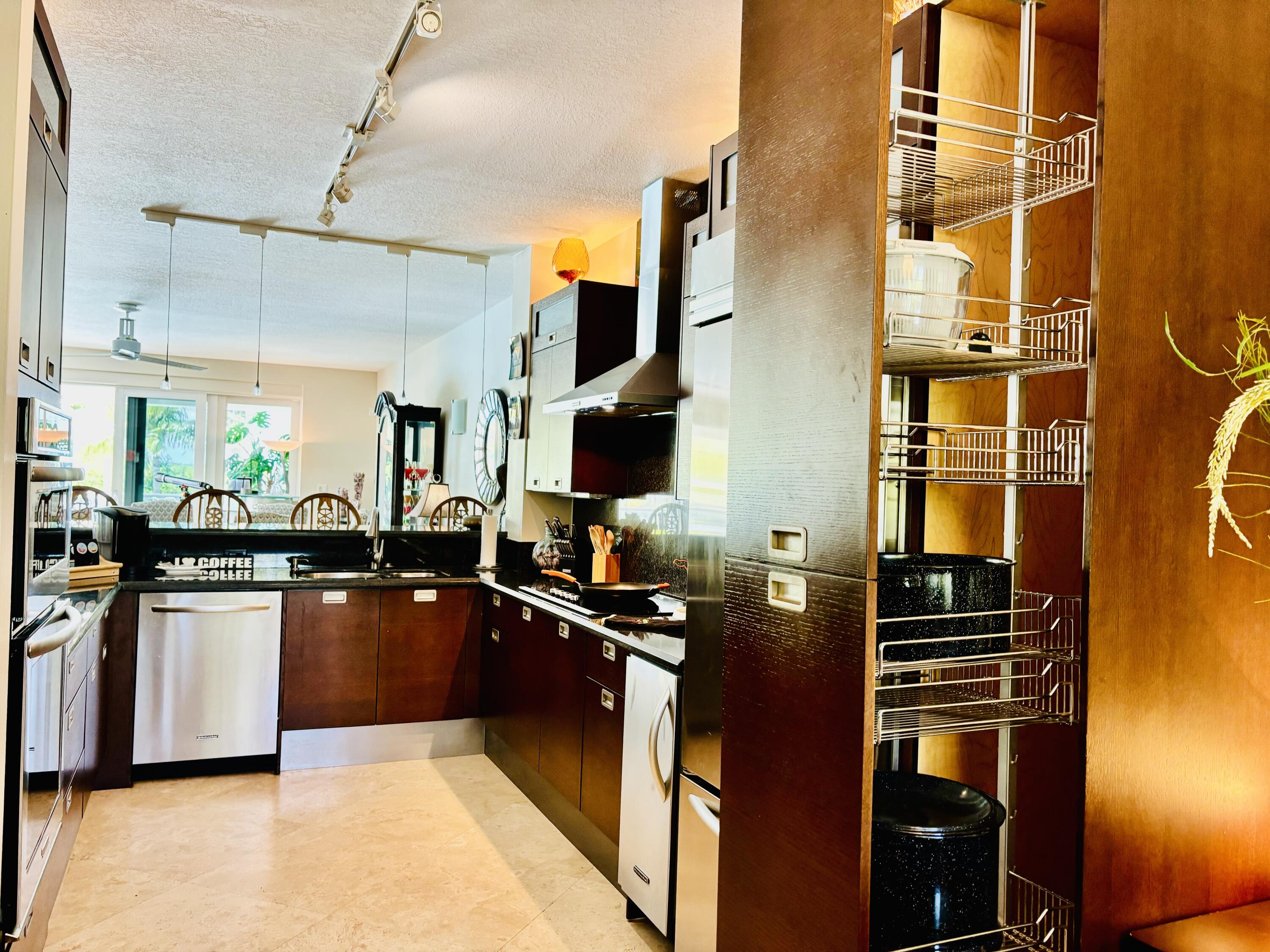 97501 Overseas Highway, Unit 521 Key Largo, FL 33037 - Photo 21 of 38 a kitchen with stainless steel appliances granite countertop a stove and a refrigerator