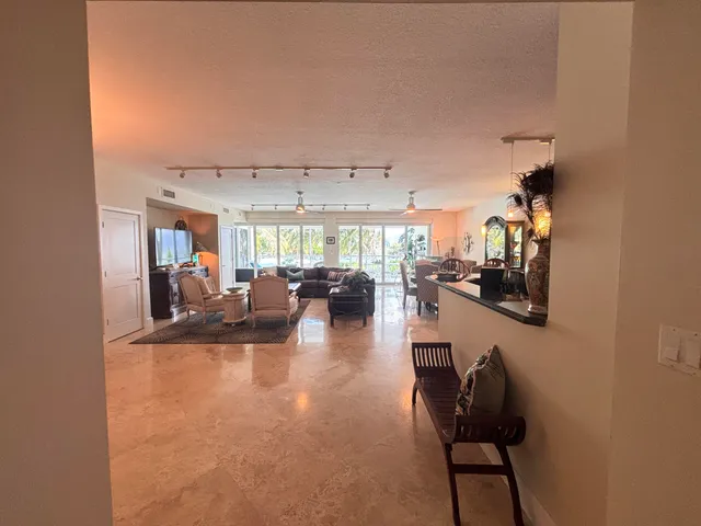 a living room with furniture a ceiling fan and a window