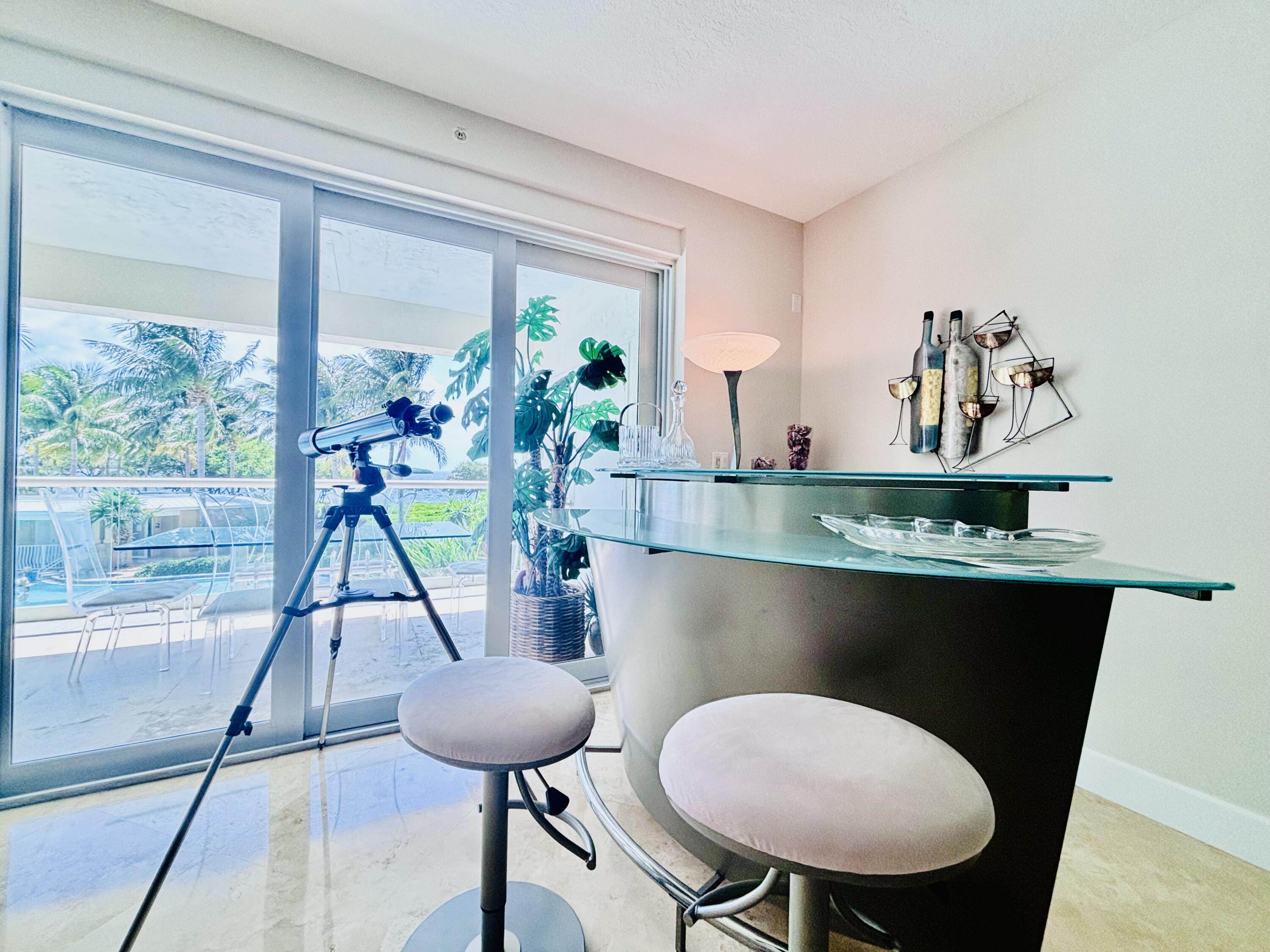 97501 Overseas Highway, Unit 521 Key Largo, FL 33037 - Photo 10 of 38 a room with a table chair and a potted plant