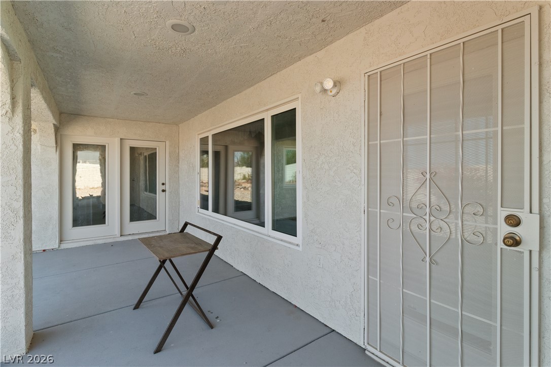 2055 Cholla Way Laughlin, NV 89029 - Photo 49 of 87 A well-lit, covered patio entrance features large windows and sturdy security doors.