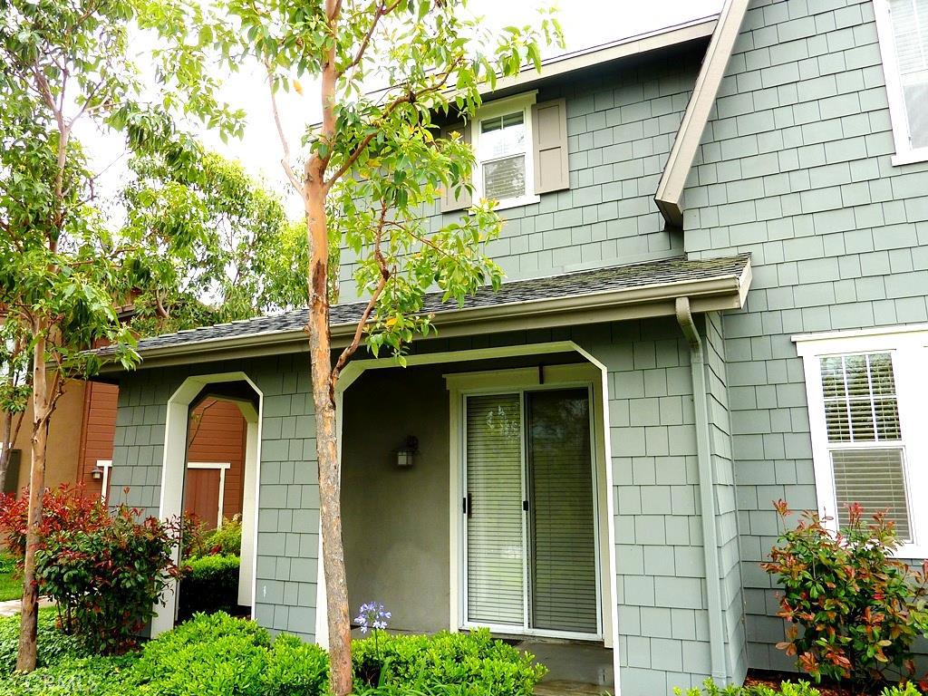 a front view of a house with plants
