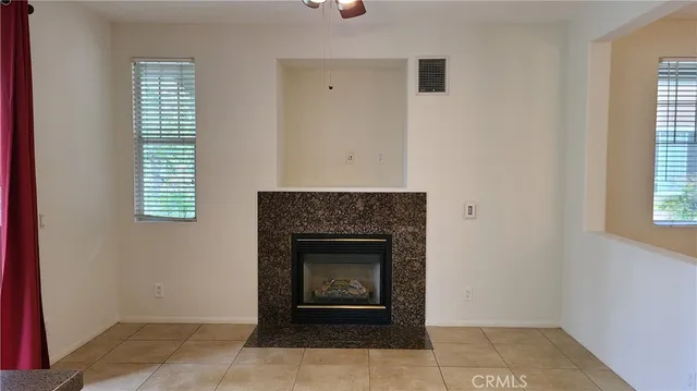 a living room with a fireplace and a window