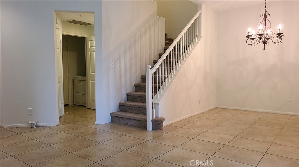 9 Garrison Loop Ladera Ranch, CA 92694 - Photo 6 of 20 a view of a hallway with entryway and chandelier