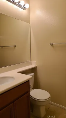 a bathroom with a granite countertop toilet and a sink