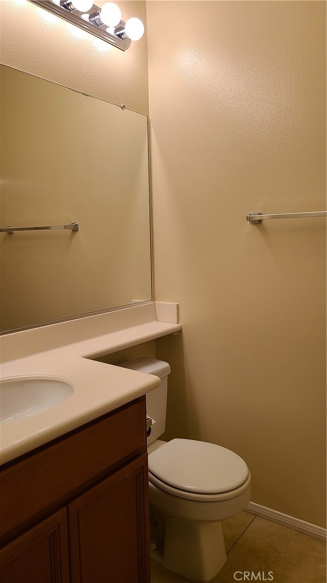 9 Garrison Loop Ladera Ranch, CA 92694 - Photo 10 of 20 a bathroom with a granite countertop toilet and a sink