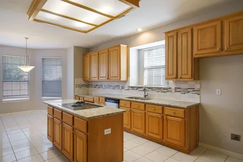 a kitchen that has a sink and a stove in it