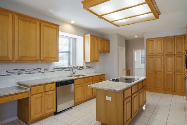 a kitchen that has a sink and a stove in it