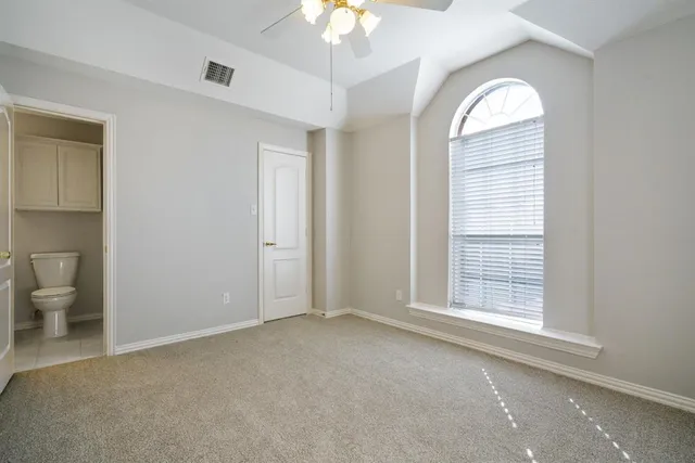 a view of a room with a windows and ceiling fan