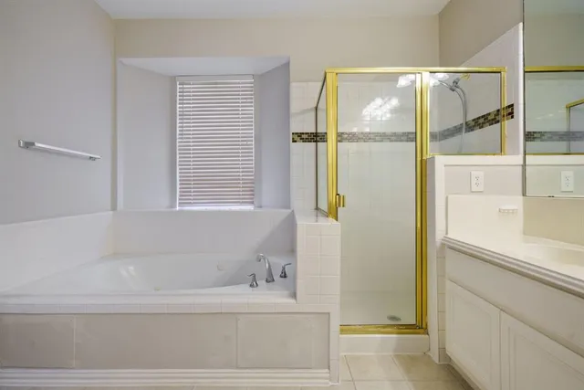 a bathroom with a bathtub and a shower