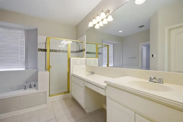 a bathroom with a tub sink and mirror