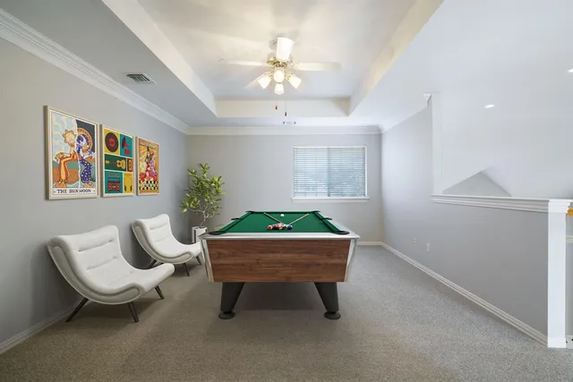 a living room with furniture a window and a potted plant
