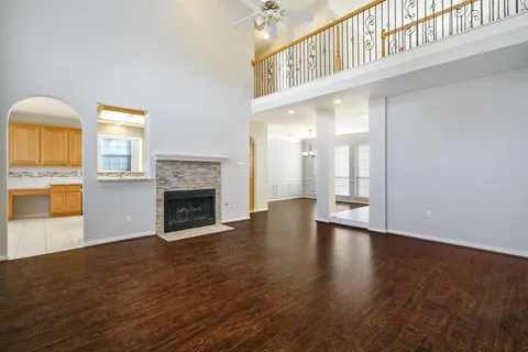 a view of an empty room with a fireplace and a window