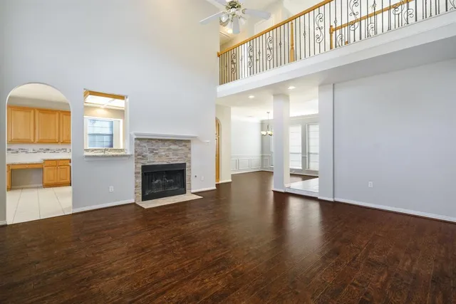 a view of an empty room with a fireplace and a window