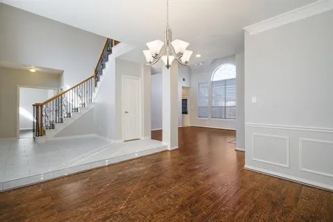 a view of a livingroom with wooden floor and a ceiling fan