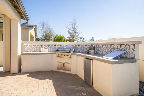 a view of kitchen with stainless steel appliances granite countertop a refrigerator and a stove