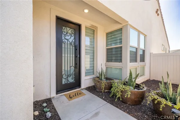a view of a hallway with wooden floor and a potted plant