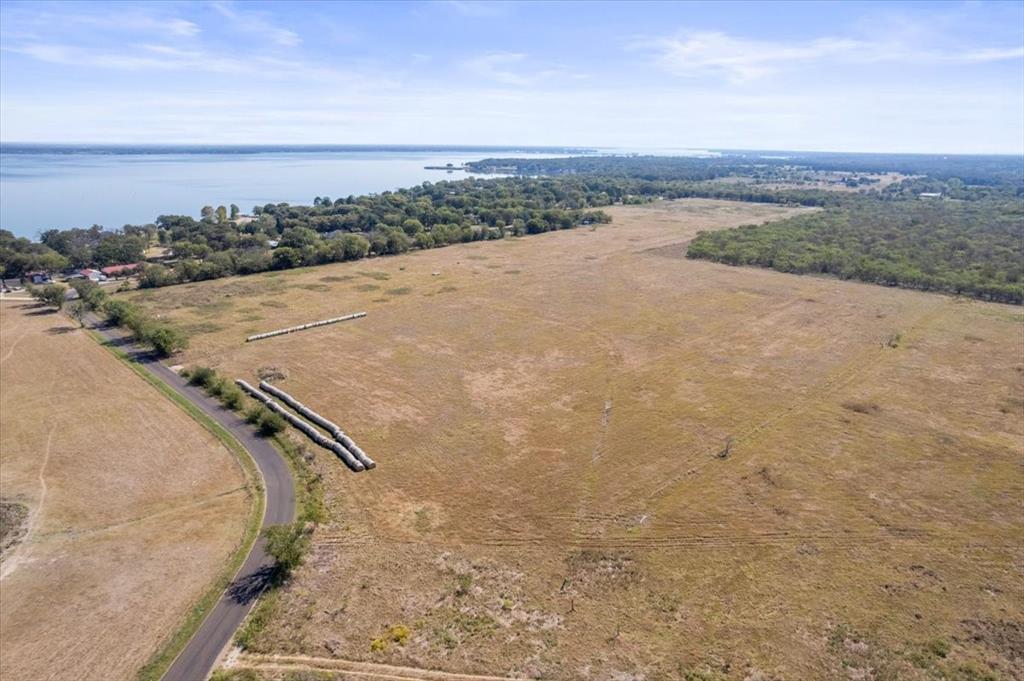 7474 County Road 4042 Kemp, TX 75143 - Photo 2 of 12 a view of a dry yard with wooden fence