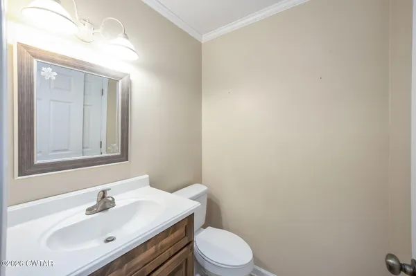 a bathroom with a sink a toilet and mirror