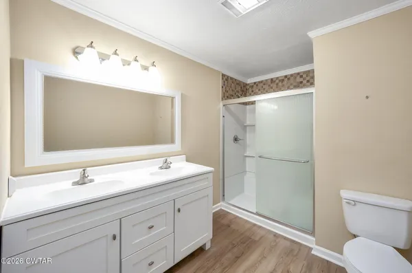 a bathroom with a double vanity sink mirror and toilet
