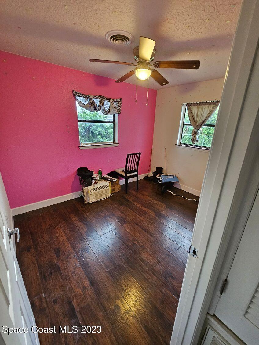 4045 Edwards Street Melbourne, FL 32901 - Photo 12 of 19 a room with wooden floor and potted plant