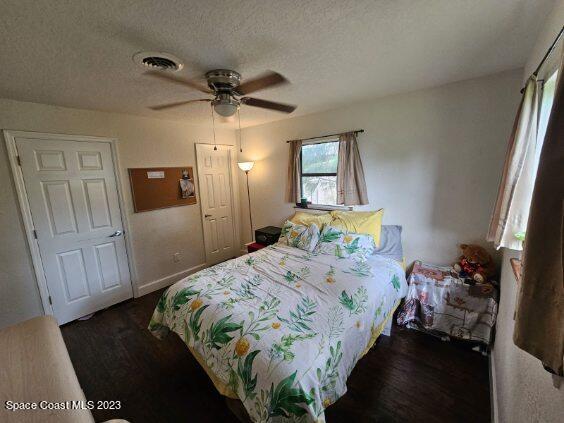 4045 Edwards Street Melbourne, FL 32901 - Photo 16 of 19 a bedroom with a bed and a mirror