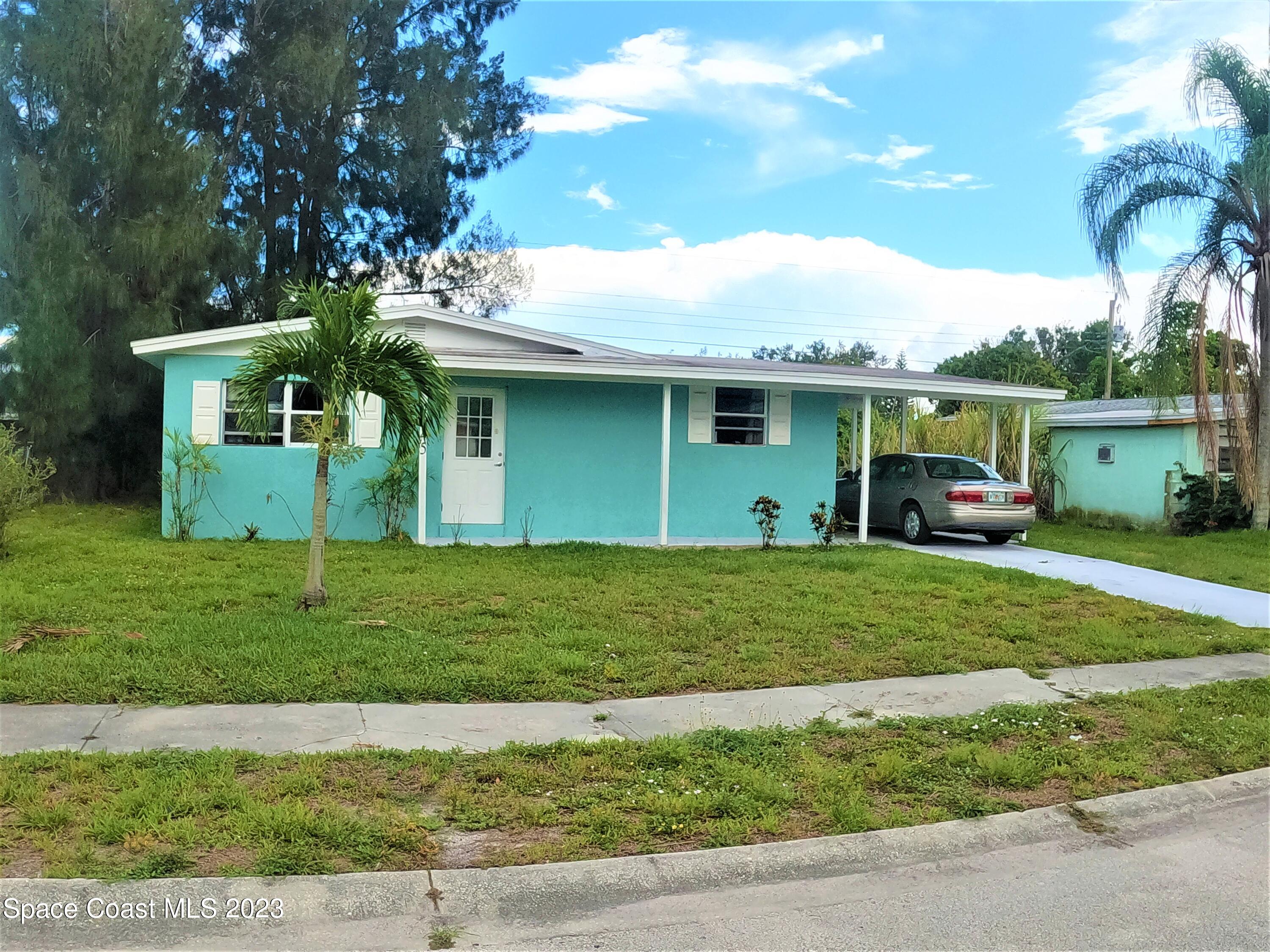 4045 Edwards Street Melbourne, FL 32901 - Photo 2 of 19 a front view of a house with a garden