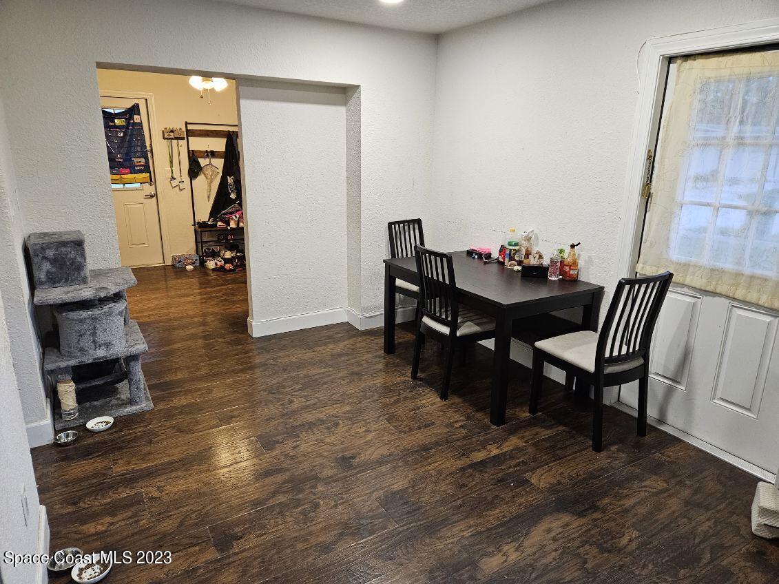 4045 Edwards Street Melbourne, FL 32901 - Photo 10 of 19 a view of a dining room with furniture and wooden floor