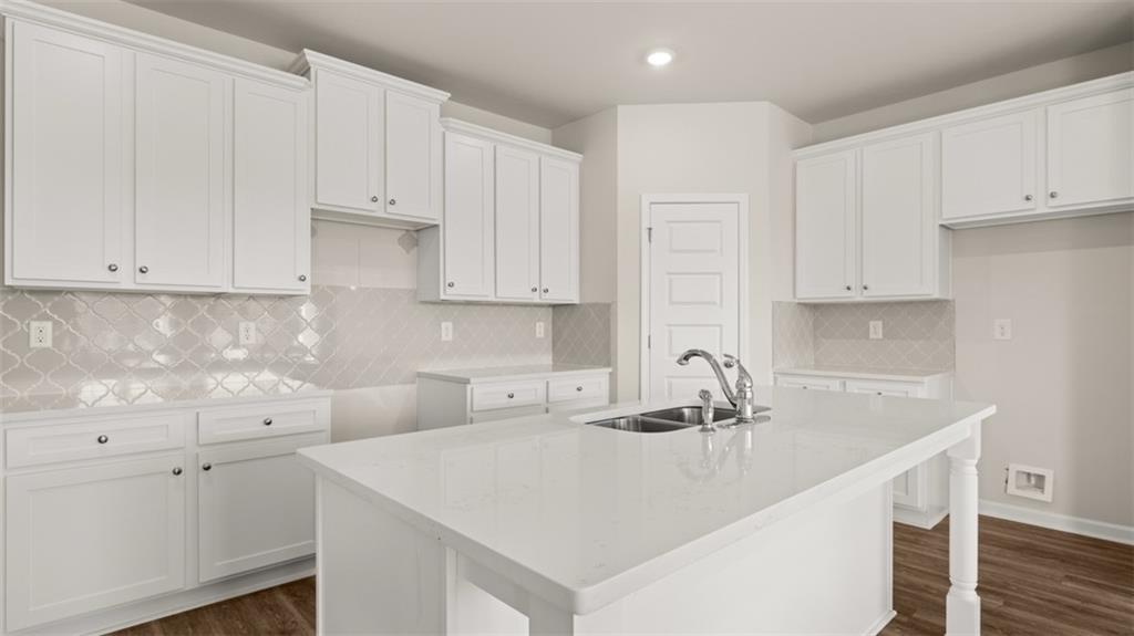 906 Stow Lane Monroe, GA 30655 - Photo 10 of 28 a kitchen with white cabinets and a sink