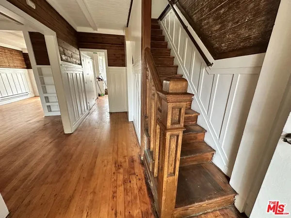 a view of an entryway with wooden floor and door