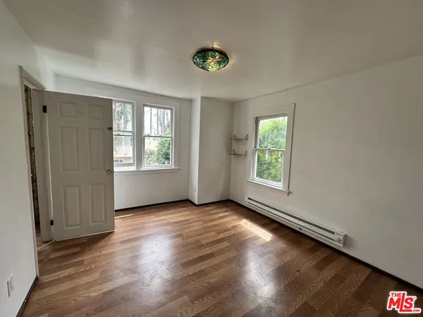 an empty room with windows and entrance
