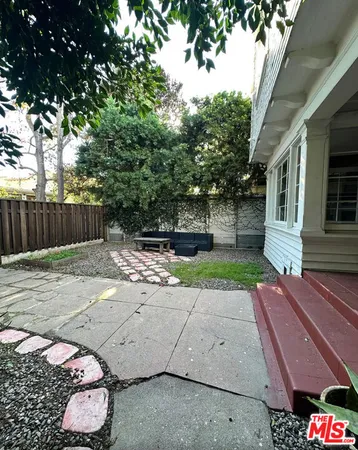 a view of a backyard with sitting area