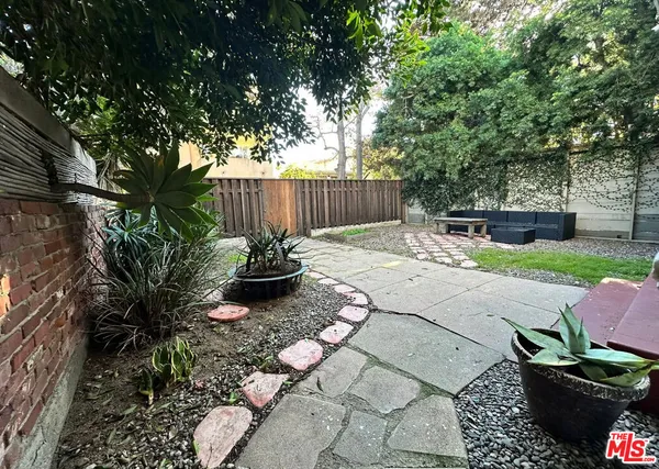 a outdoor living space with furniture and a rug