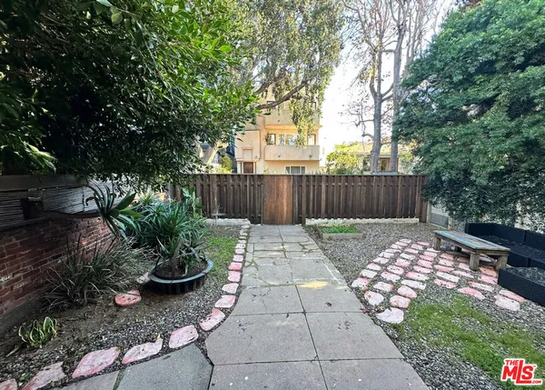 a view of patio with wooden fence