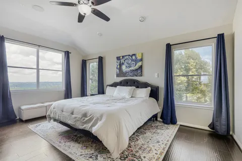 a bedroom with a large bed and a window