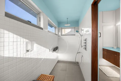 a bathroom with a toilet and a shower