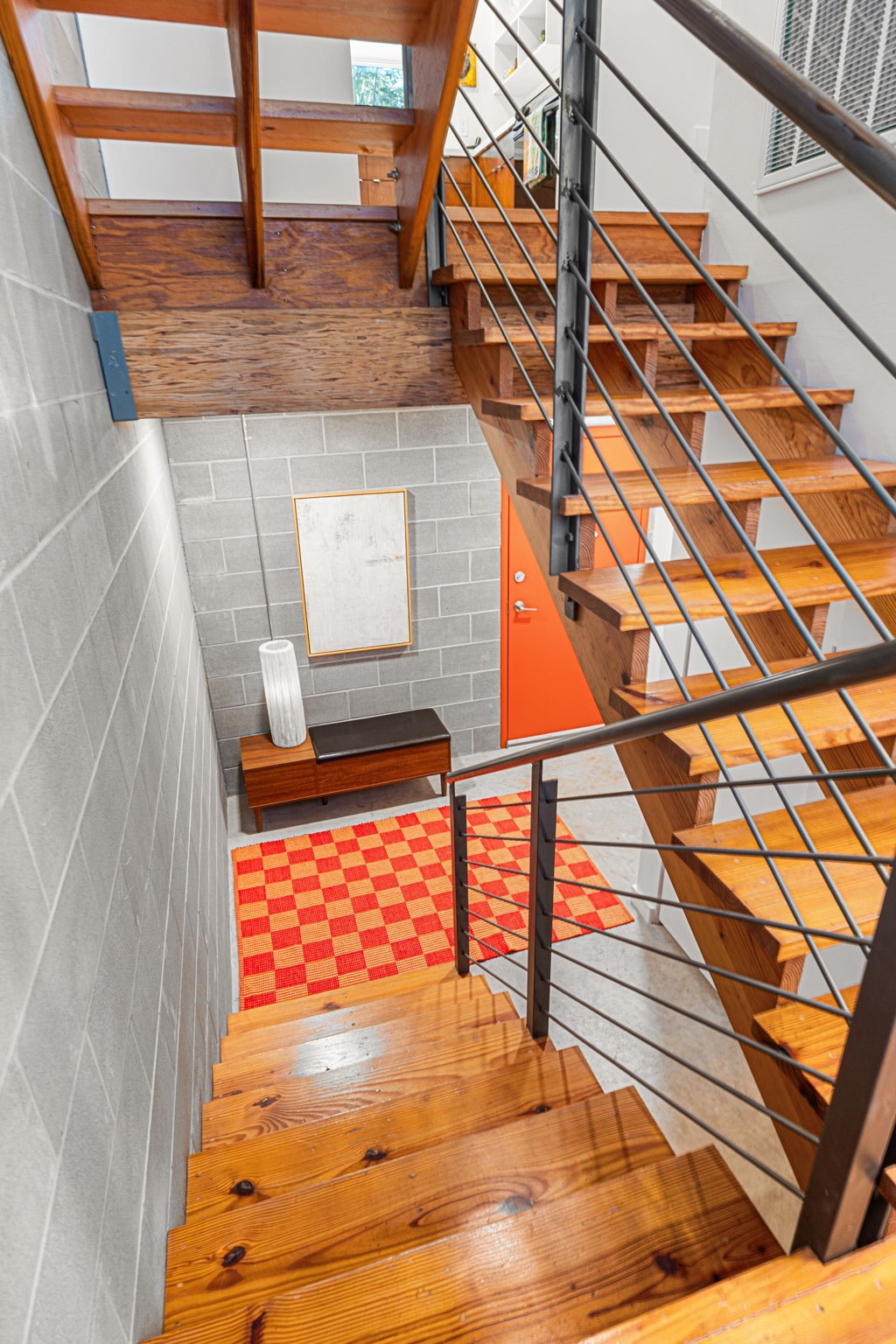 5811 Rose Street Houston, TX 77007 - Photo 4 of 40 The entryway highlights the clean lines, pops of color, and simple yet durable materials throughout such as Southern Yellow Pine Flooring and custom metal railing.