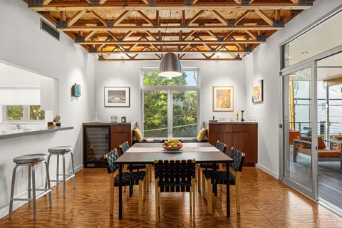 a living room with furniture a rug and a large window