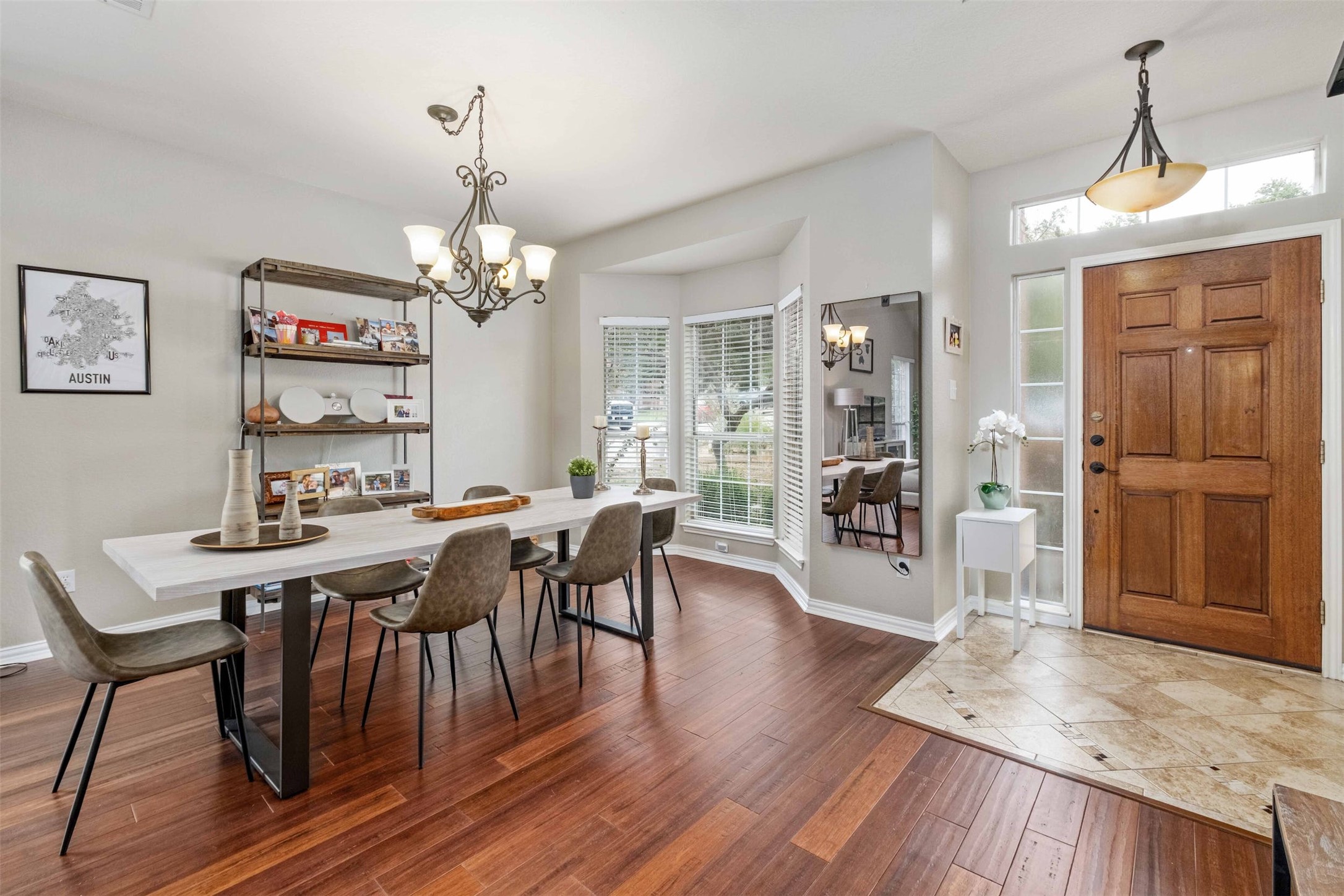 3704 Runnels Court Austin, TX 78732 - Photo 2 of 30 Dining area with baseboards, an inviting chandelier, and wood finished floors