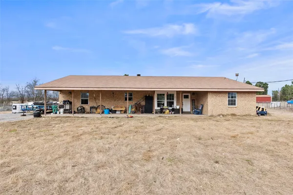 a front view of a house with a yard and seating space